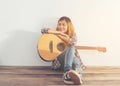 Hipster woman style portrait chillinÃ¢â¬â¢ with guitar look so happy. Royalty Free Stock Photo